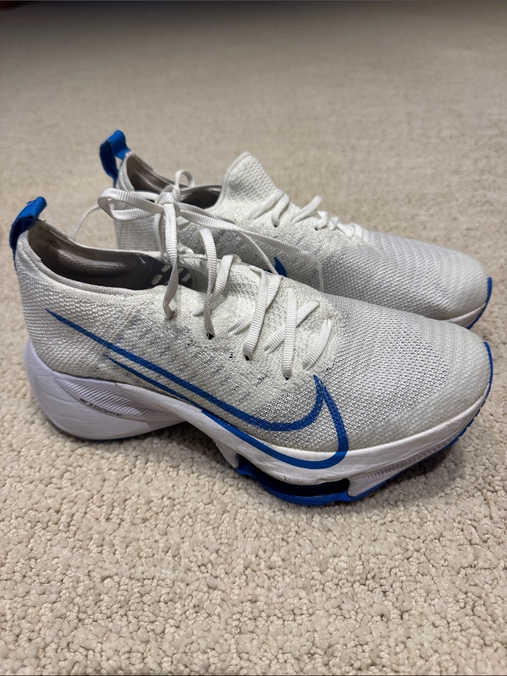 Nike White Flyknit Running Sneakers with Blue Swoosh